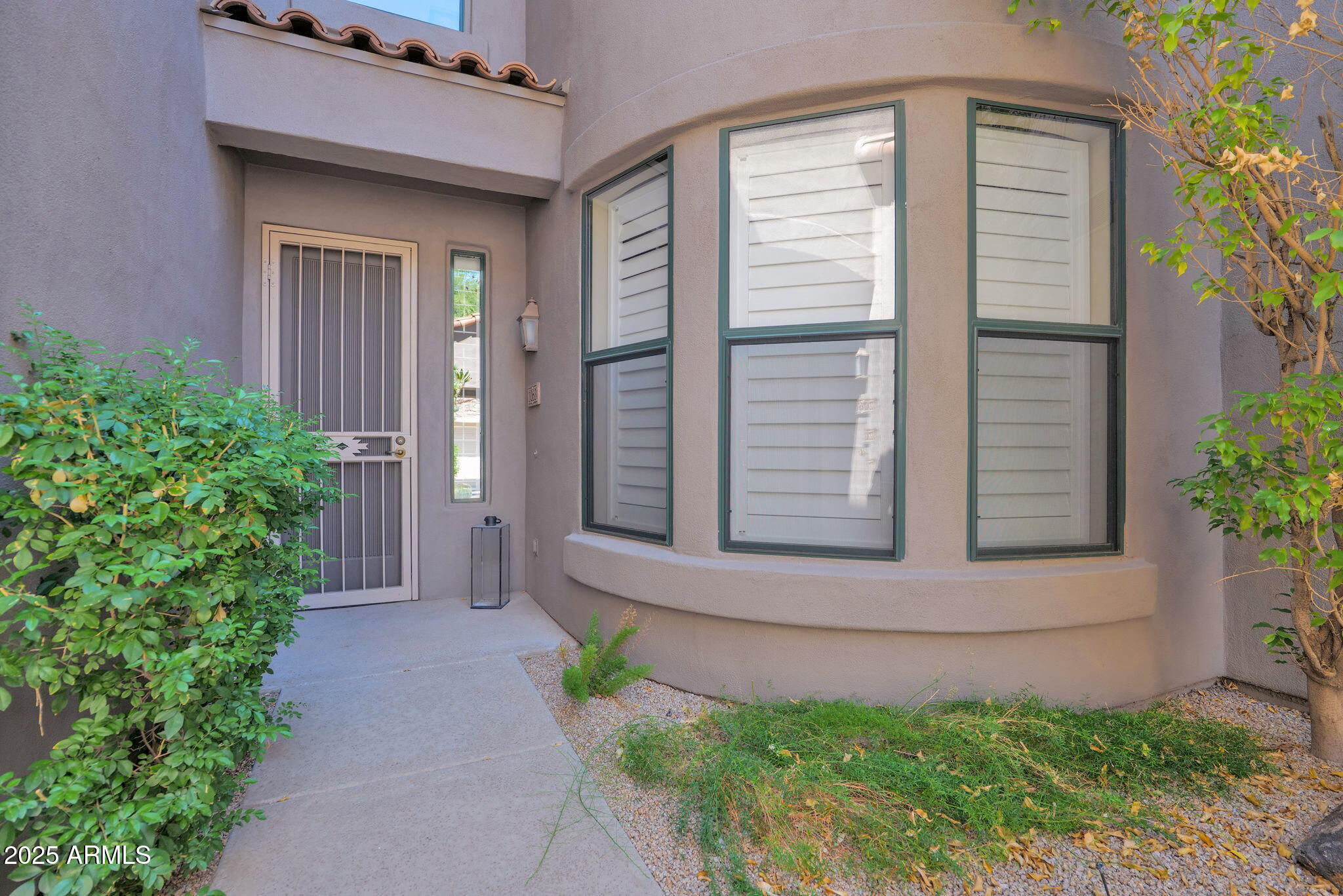 19550 North Grayhawk Drive, Unit 1063 Scottsdale, AZ 85255 - Photo 29 of 40 a front view of a house with a yard and garage