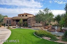 19550 North Grayhawk Drive, Unit 1063 Scottsdale, AZ 85255 - Photo 35 of 40 a view of a house with a big yard potted plants and large tree