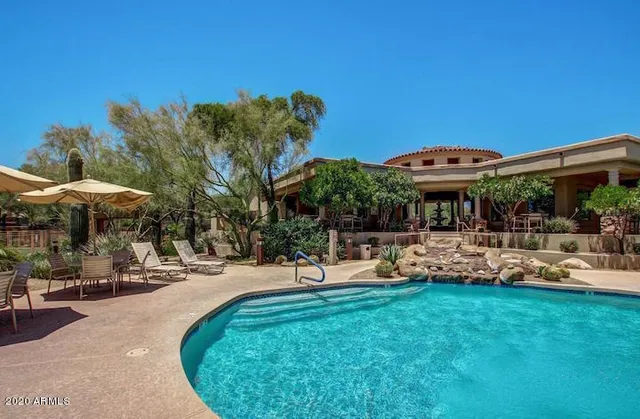 a view of a house with swimming pool and sitting area