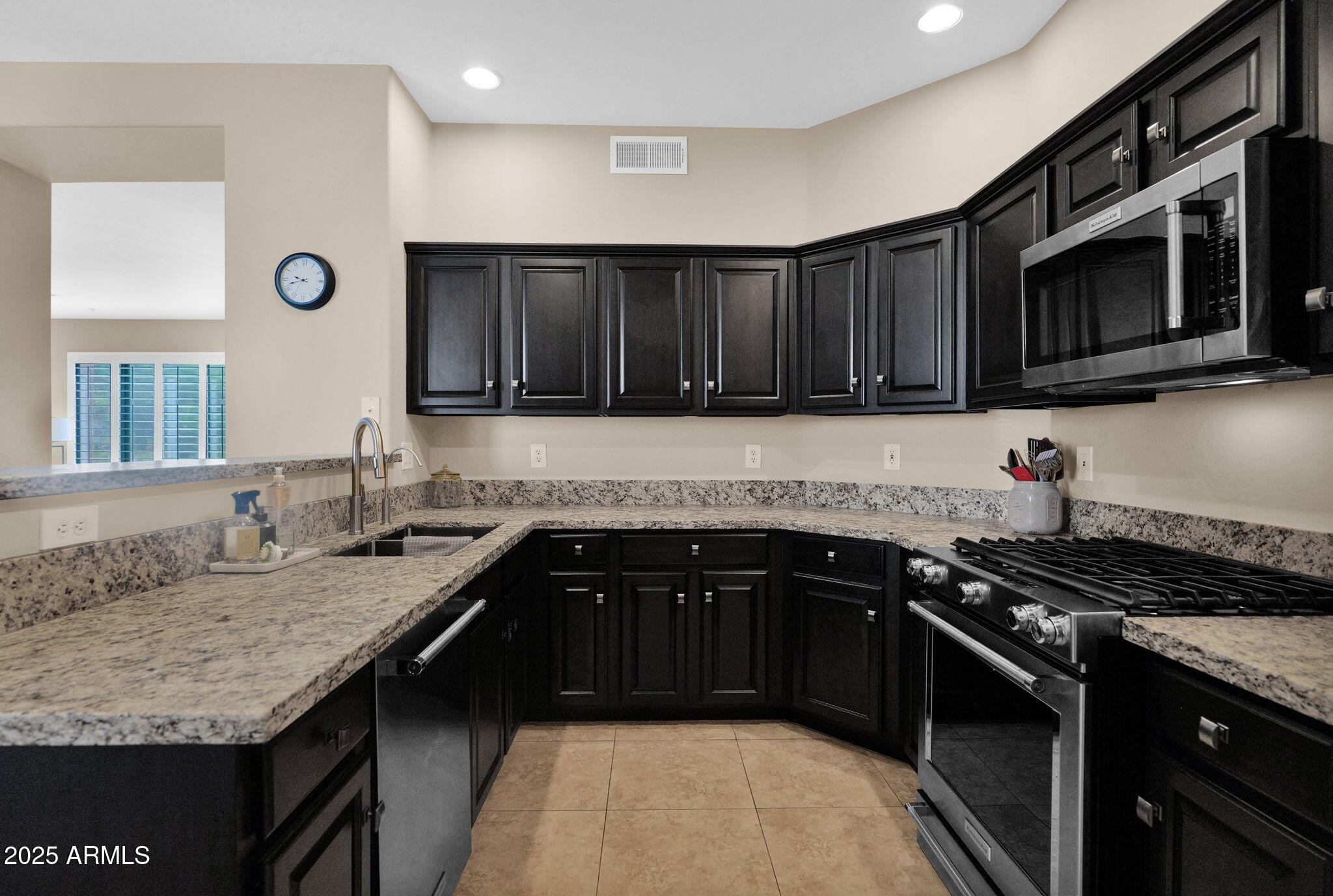 19550 North Grayhawk Drive, Unit 1063 Scottsdale, AZ 85255 - Photo 8 of 40 a kitchen with granite countertop a stove and a sink