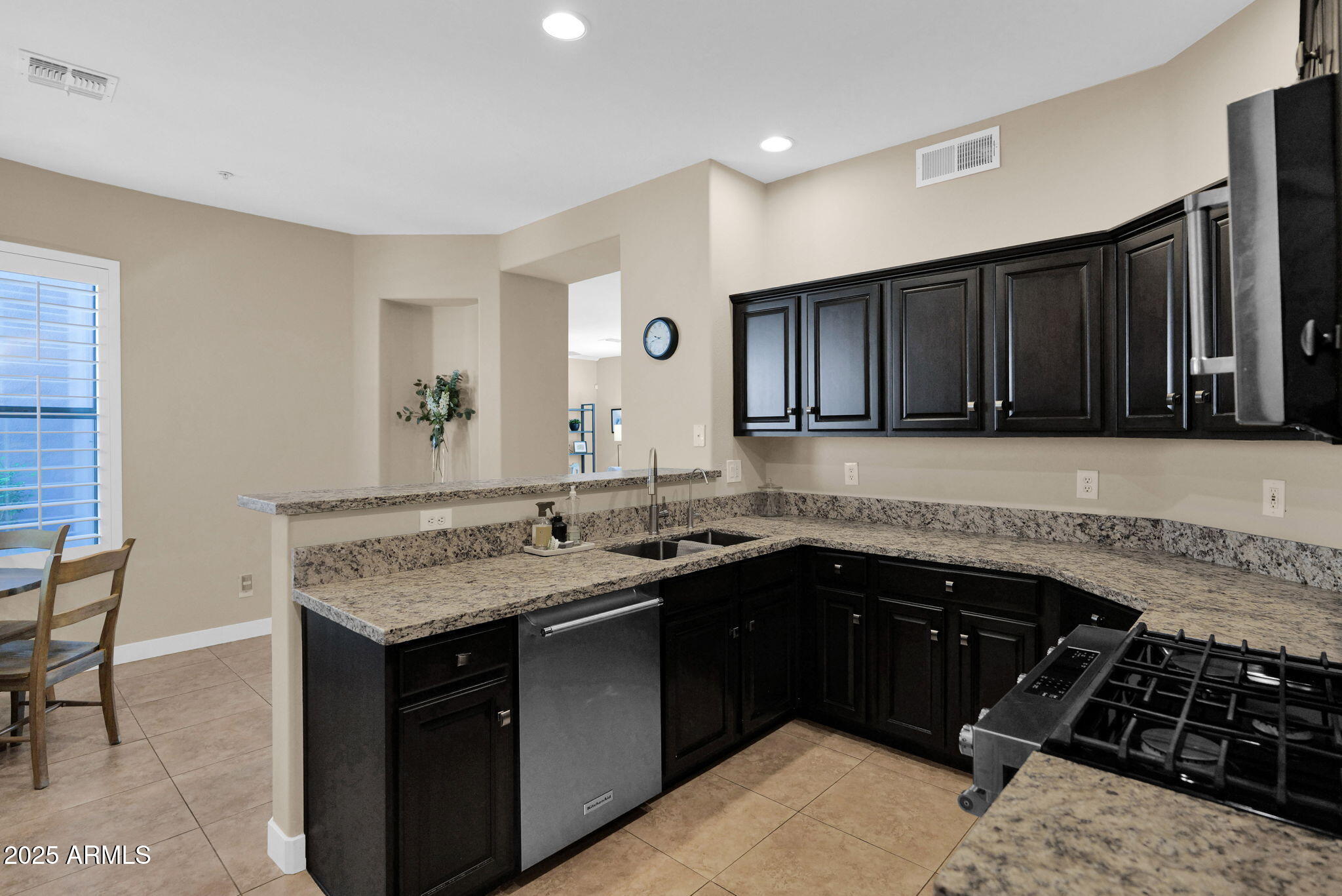 19550 North Grayhawk Drive, Unit 1063 Scottsdale, AZ 85255 - Photo 9 of 40 a kitchen with a sink and a stove top oven