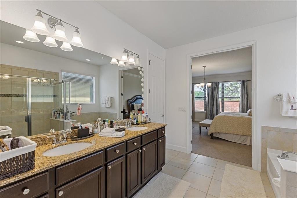 7180 Beek Street Windermere, FL 34786 - Photo 14 of 33 a spacious bathroom with a double vanity sink double vanity and mirror