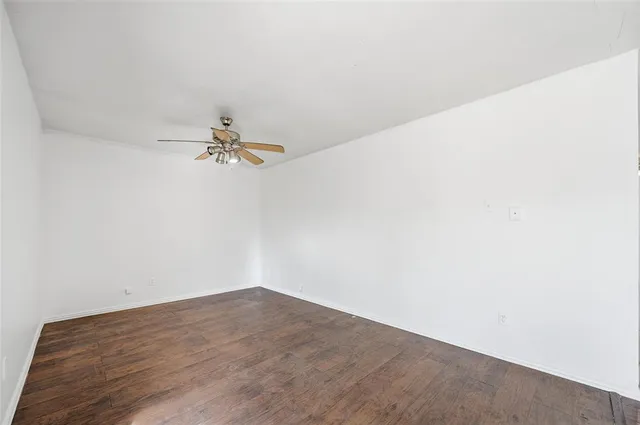 a view of a room with wooden floor