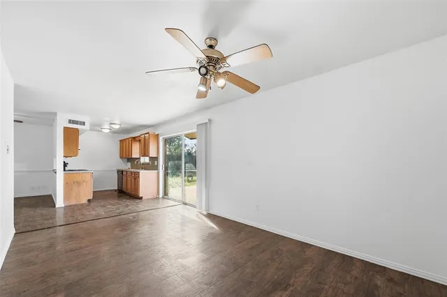 a view of a kitchen with furniture and wooden floor