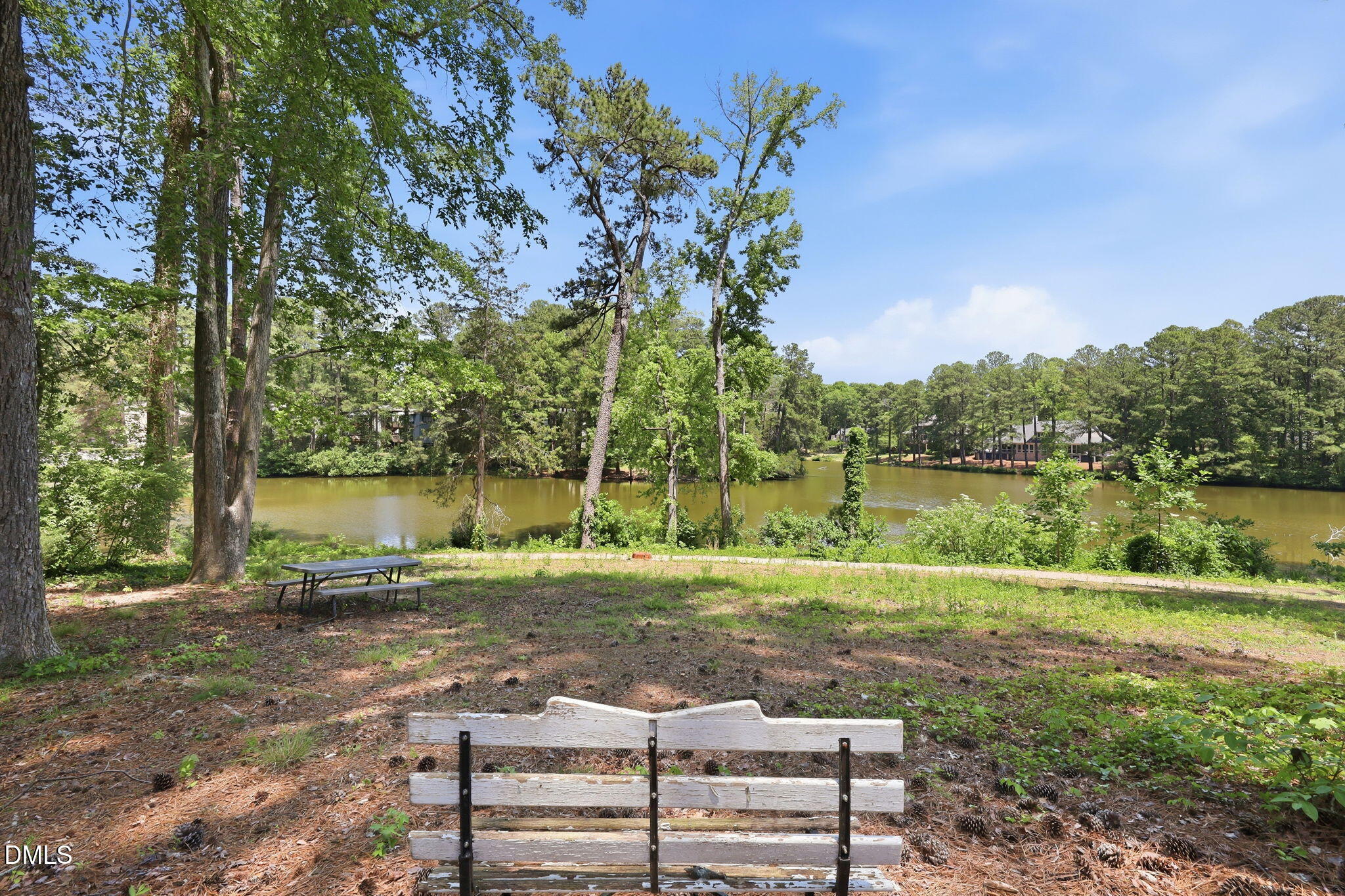 5043 Tall Pines Court Raleigh, NC 27609 - Photo 32 of 37 a view of a lake with a yard and potted plants
