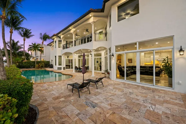 an aerial view of a house with swimming pool patio and outdoor seating