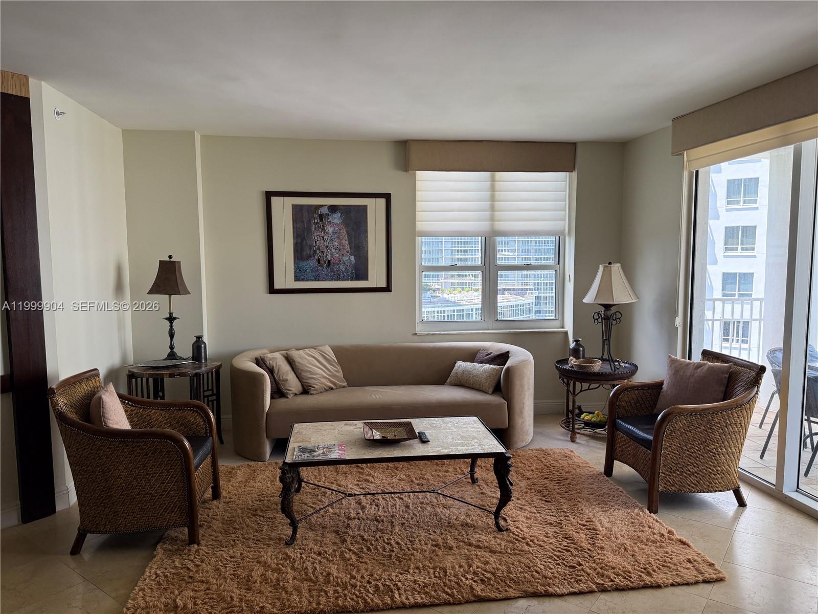 701 Brickell Key Boulevard, Unit 2104 Miami, FL 33131 - Photo 2 of 13 a living room with furniture or couch and a window