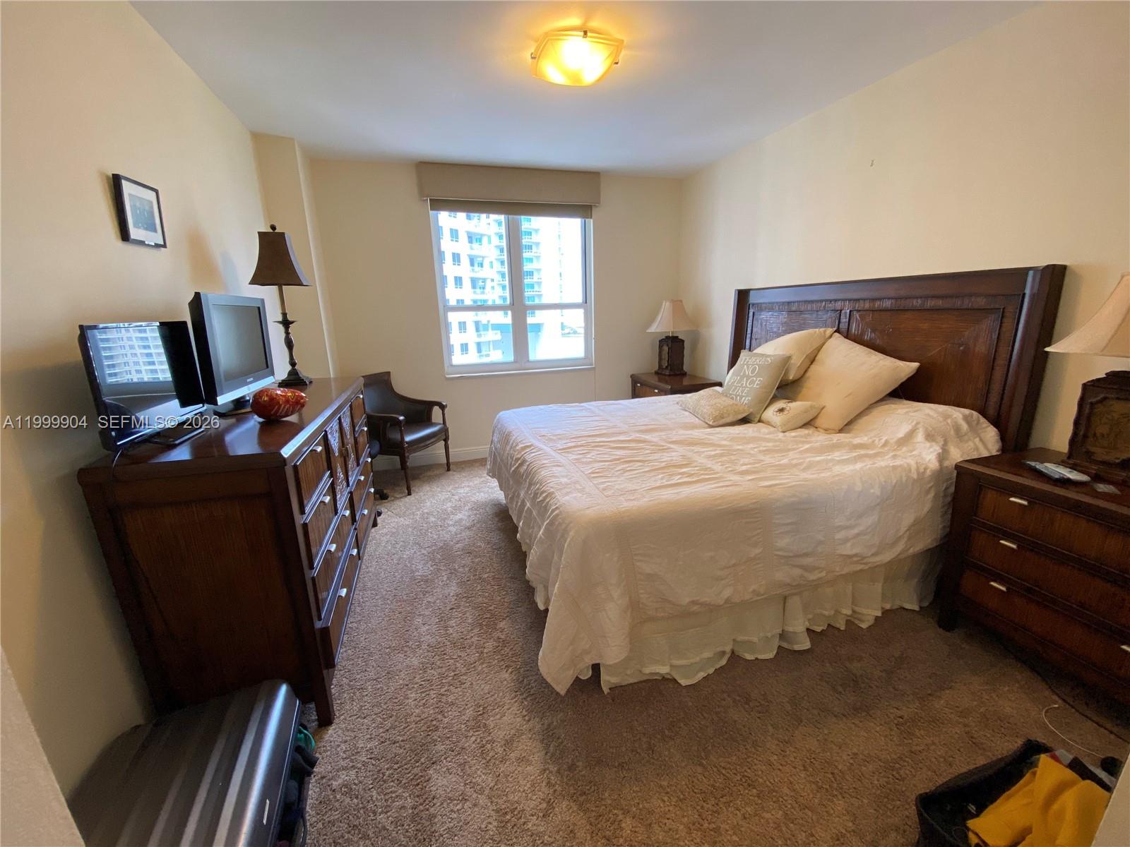 701 Brickell Key Boulevard, Unit 2104 Miami, FL 33131 - Photo 7 of 13 a bedroom with bed and window