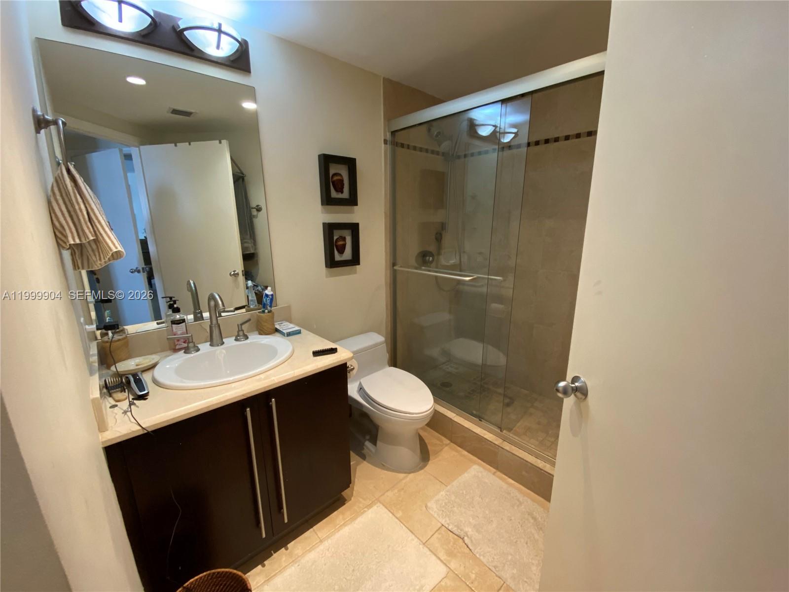 701 Brickell Key Boulevard, Unit 2104 Miami, FL 33131 - Photo 8 of 13 a bathroom with a sink toilet and shower