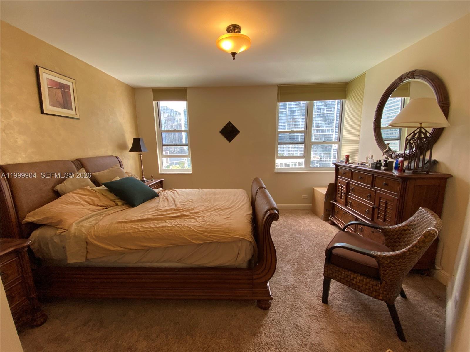 701 Brickell Key Boulevard, Unit 2104 Miami, FL 33131 - Photo 9 of 13 a bedroom with a bed and wooden floor