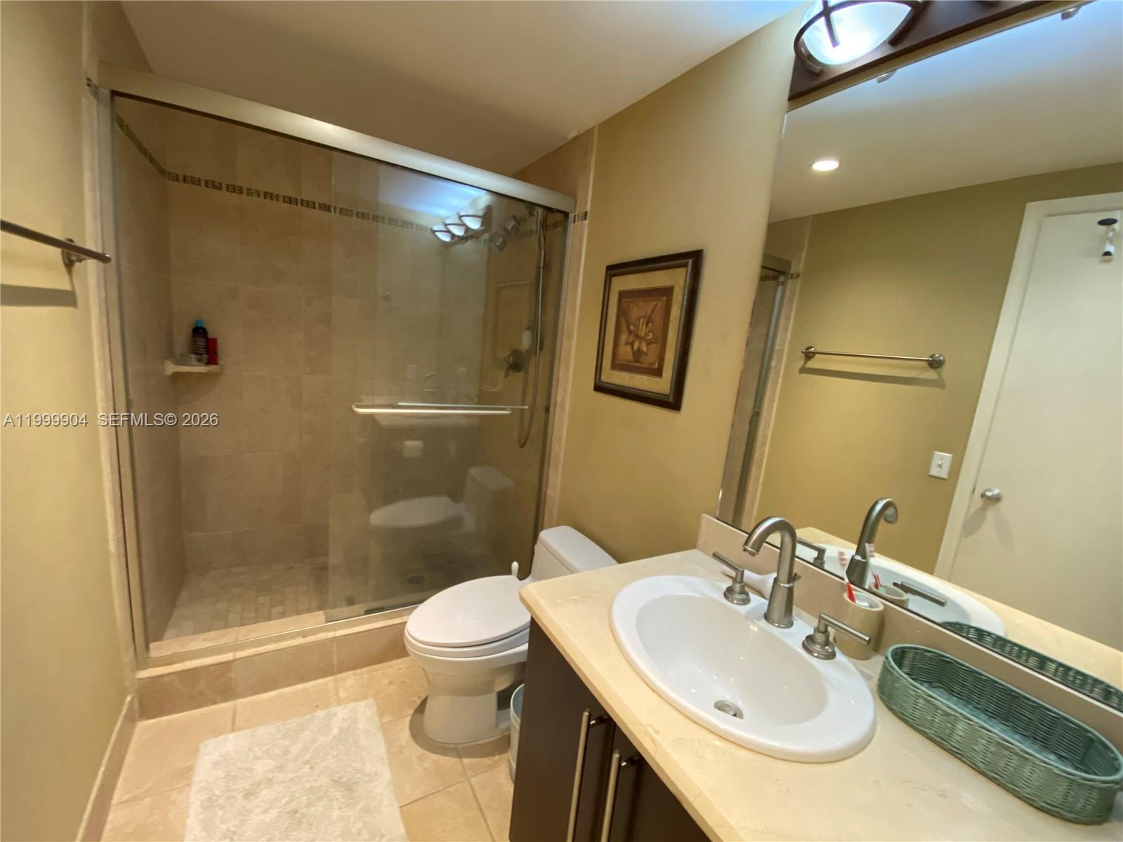 701 Brickell Key Boulevard, Unit 2104 Miami, FL 33131 - Photo 10 of 13 a bathroom with a sink toilet and shower