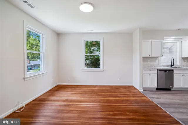 a view of a room with wooden floor and window