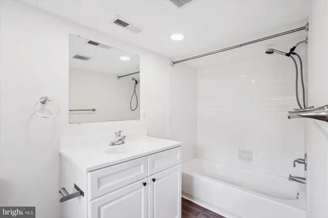 a view of a kitchen with wooden floor and a window
