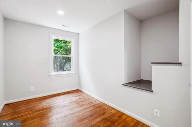 a view of room with window and wooden floor
