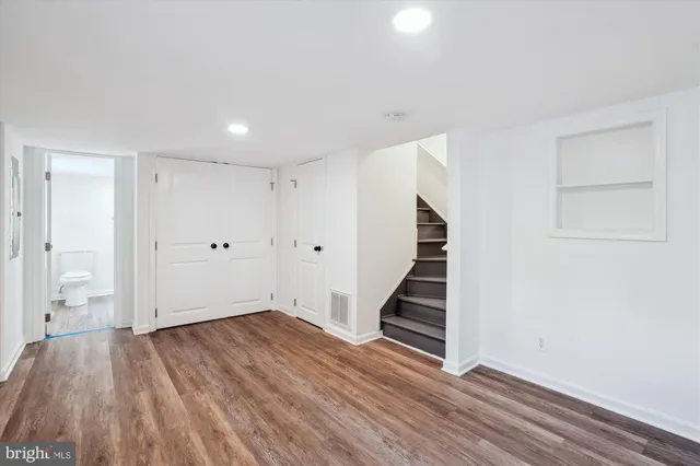 a view of entryway and hall with wooden floor