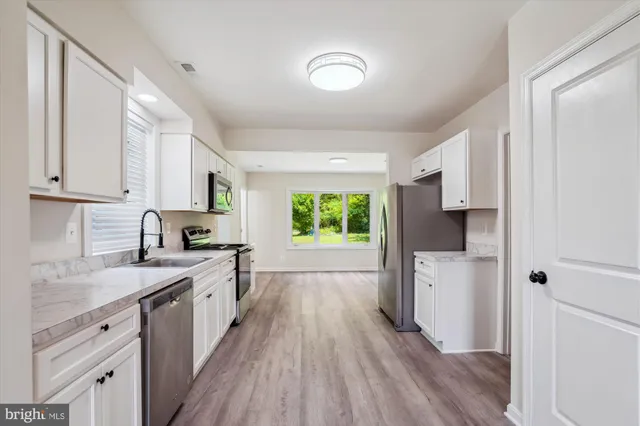 a view of kitchen with wooden floor