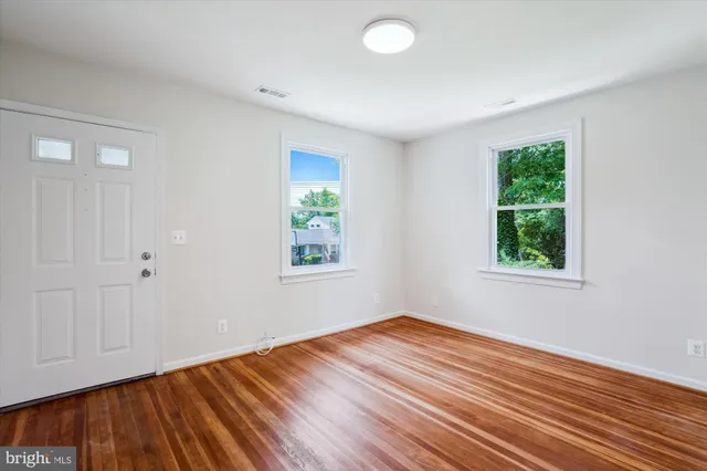 a view of a kitchen with wooden floor and a sink