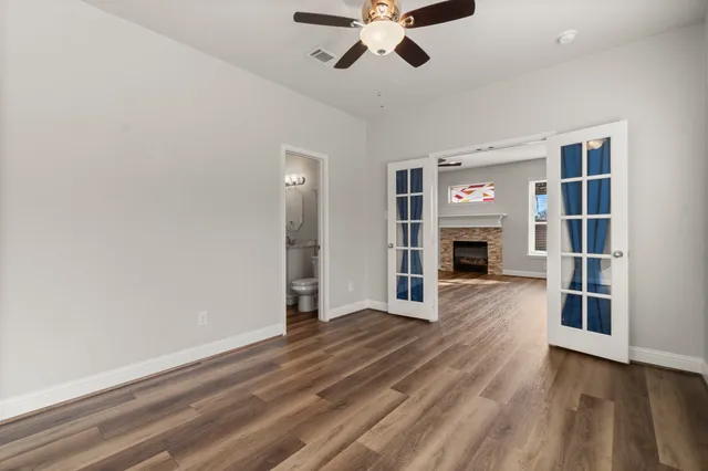 an empty room with furniture and a fireplace