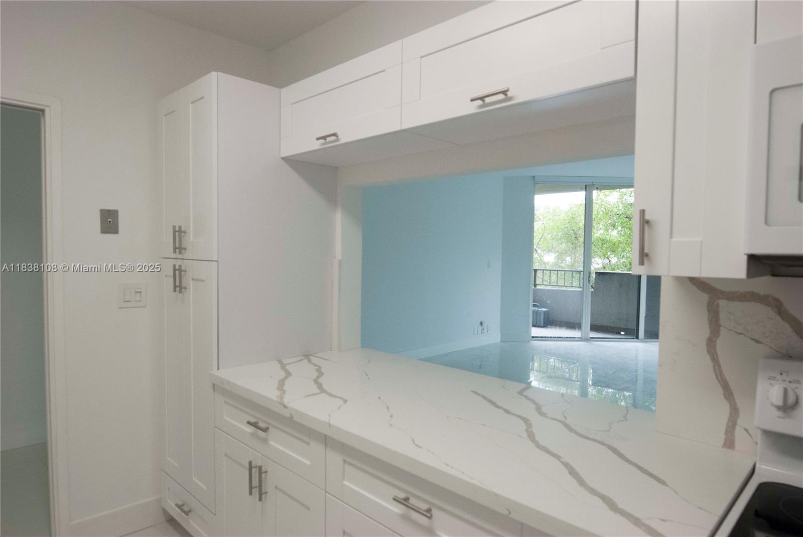 141 Crandon Boulevard, Unit 342 Key Biscayne, FL 33149 - Photo 13 of 25 a bathroom with a granite countertop sink a toilet and shower