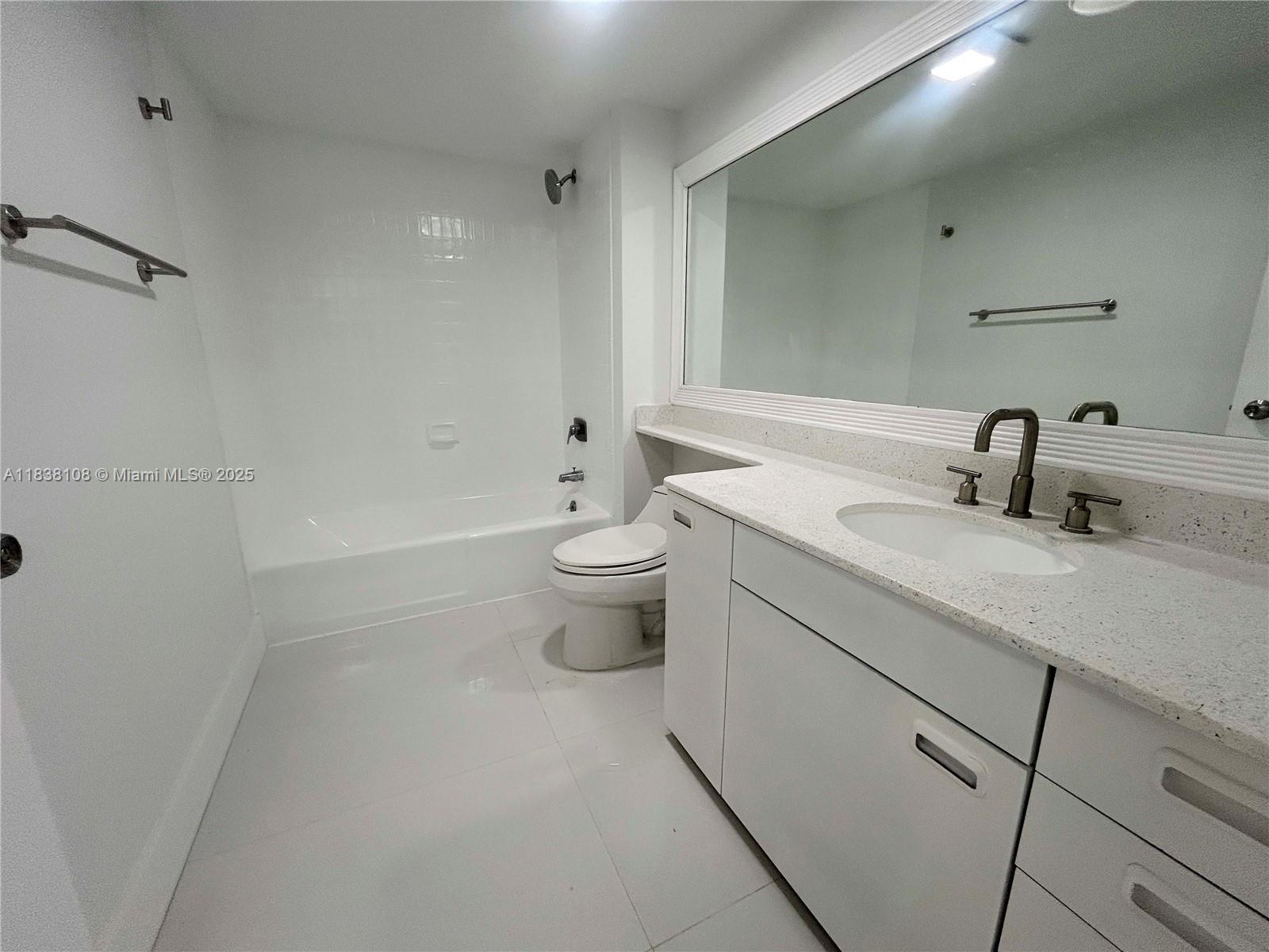 141 Crandon Boulevard, Unit 342 Key Biscayne, FL 33149 - Photo 15 of 25 a bathroom with a sink a toilet and shower