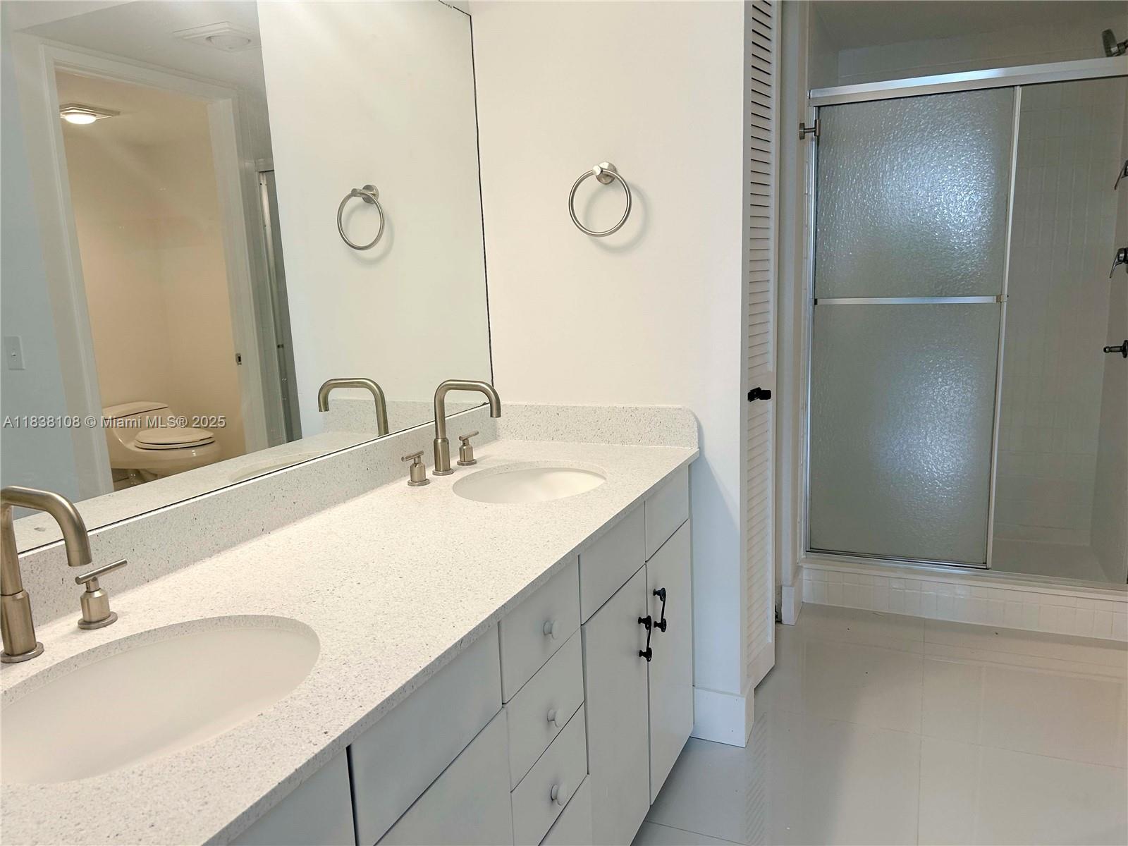 141 Crandon Boulevard, Unit 342 Key Biscayne, FL 33149 - Photo 16 of 25 a bathroom with a sink and a mirror
