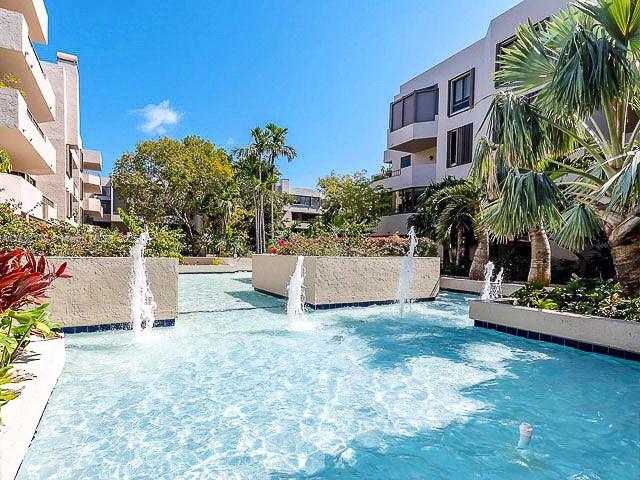 141 Crandon Boulevard, Unit 342 Key Biscayne, FL 33149 - Photo 22 of 25 a view of a white house with a yard and plants