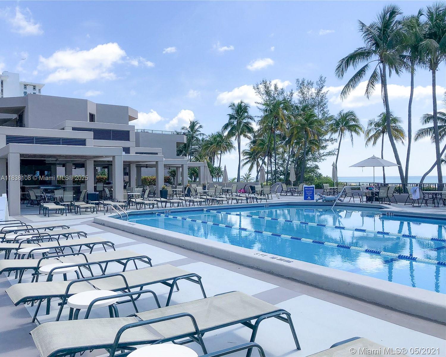 141 Crandon Boulevard, Unit 342 Key Biscayne, FL 33149 - Photo 23 of 25 a swimming pool with outdoor seating and yard