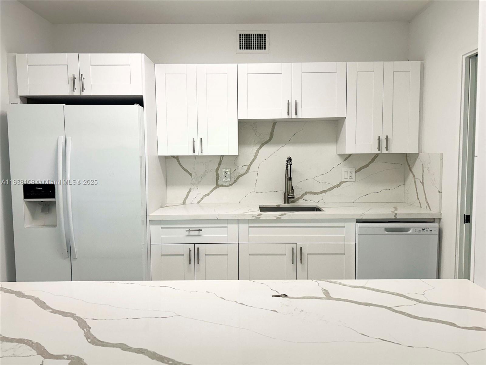 141 Crandon Boulevard, Unit 342 Key Biscayne, FL 33149 - Photo 10 of 25 a kitchen with cabinets appliances and a counter space