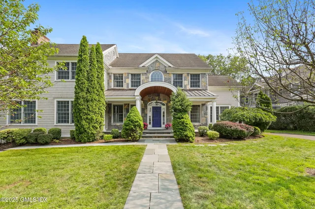 a view of an empty room with wooden floor and windows