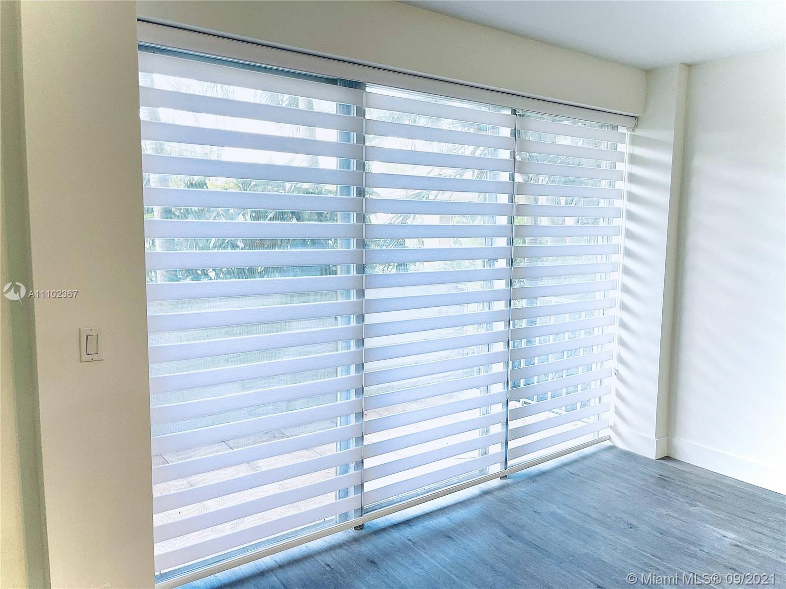 880 Northeast 69th Street, Unit 1D Miami, FL 33138 - Photo 13 of 15 a view of walk in closet with empty racks
