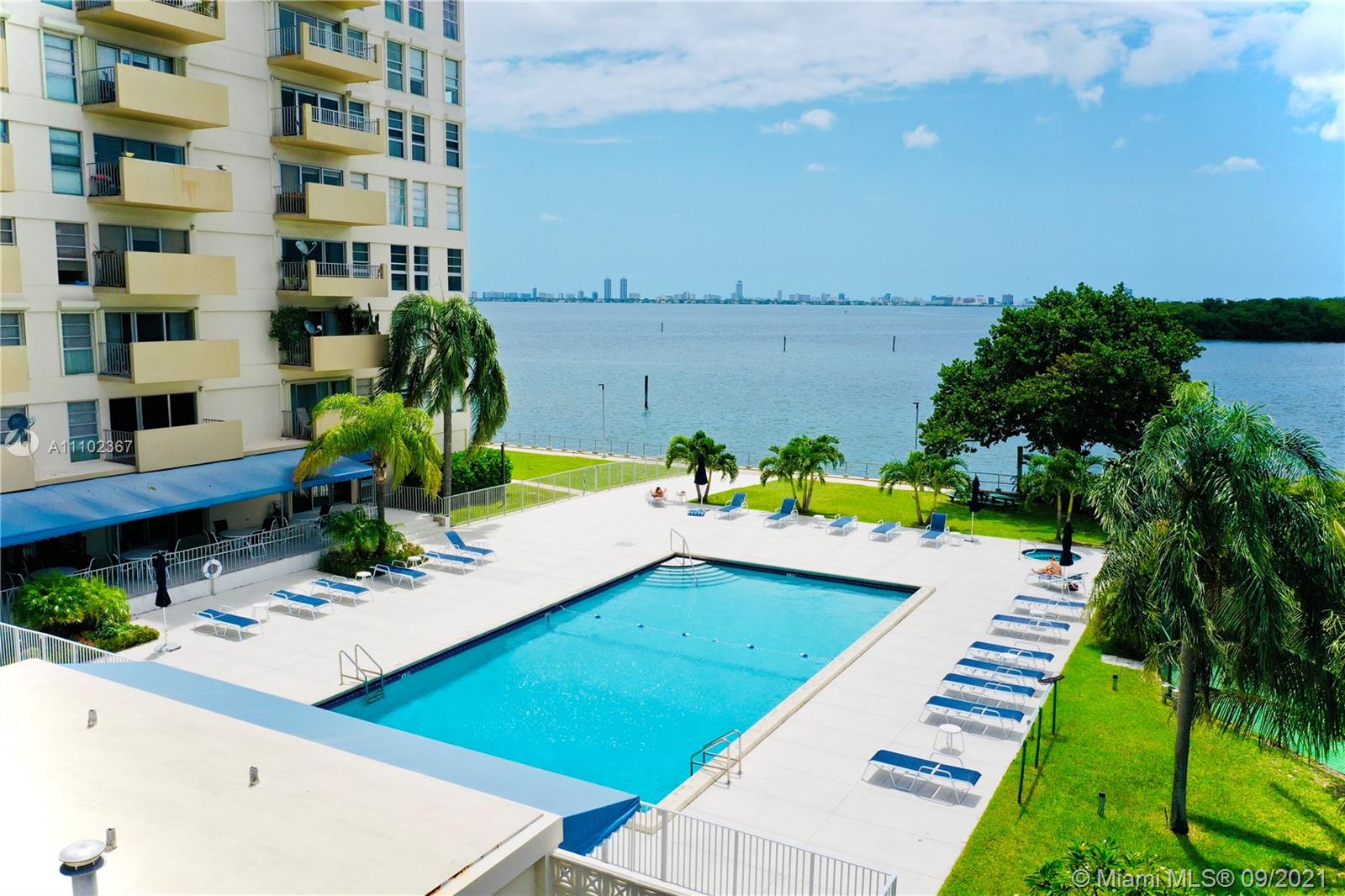 880 Northeast 69th Street, Unit 1D Miami, FL 33138 - Photo 9 of 15 a view of a swimming pool with an outdoor seating and a garden