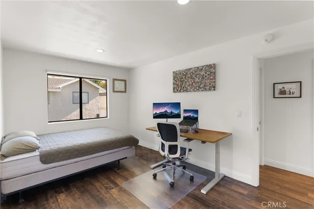 a view of a livingroom with workspace and a couch