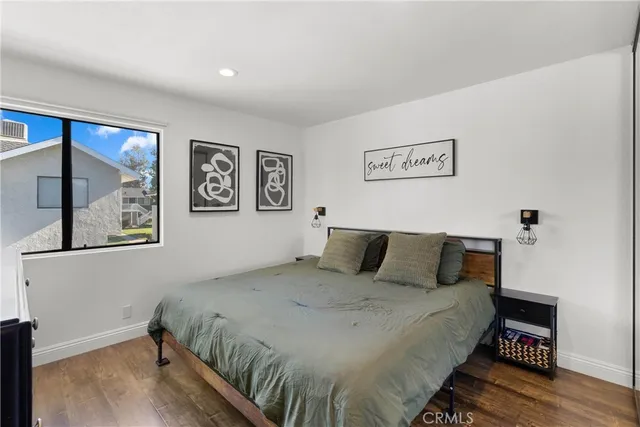 a bedroom with a bed and a painting on the wall