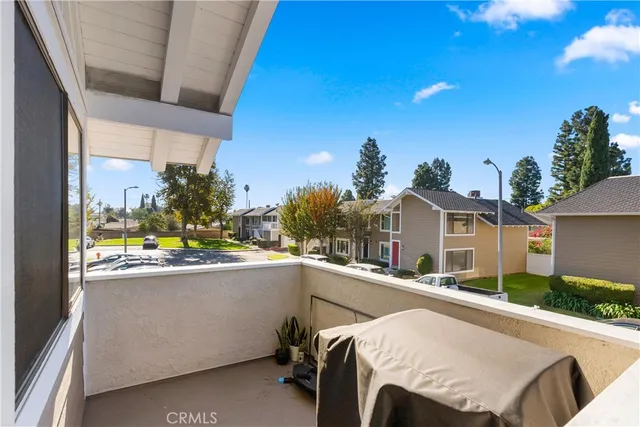 a view of a white house next to a yard