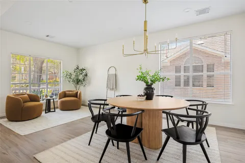 a dining room with furniture and wooden floor