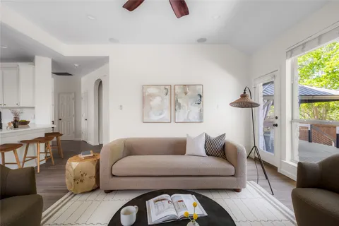a living room with furniture a window and a fireplace