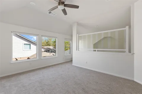 a view of an empty room with a ceiling fan