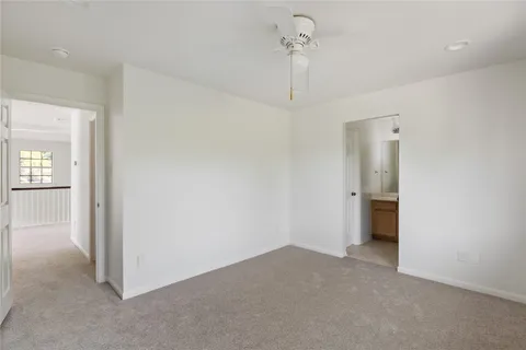 an empty room with a window and a bathroom