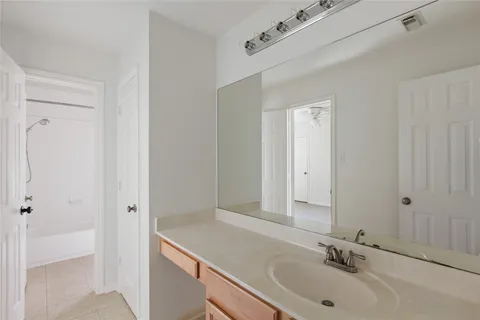 a view of a room with a chandelier fan and closet area