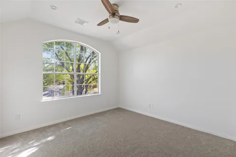a view of a big room with a ceiling fan