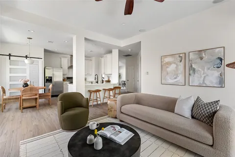 a living room with furniture and a wooden floor