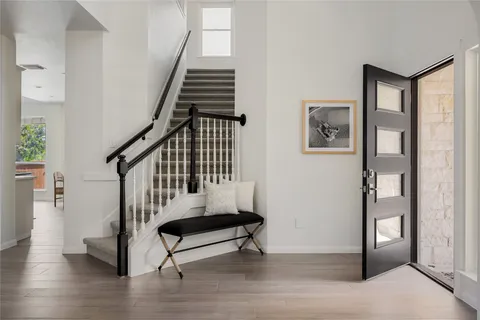 a view of entryway with wooden floor and stairs