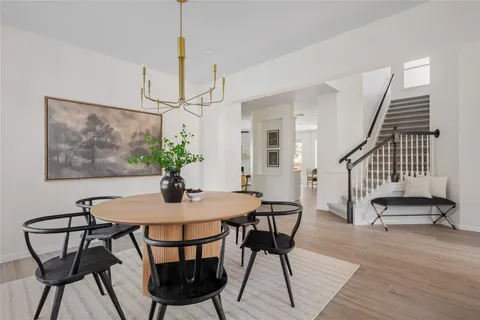 a view of a dining room with furniture wooden floor and a chandelier