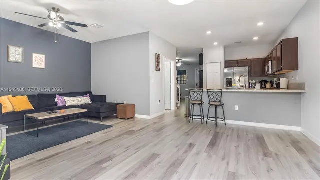 a living room with furniture and kitchen view