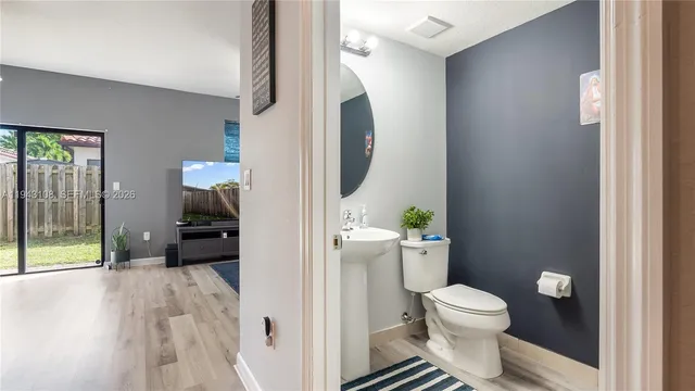 a bathroom with a toilet a sink and a mirror
