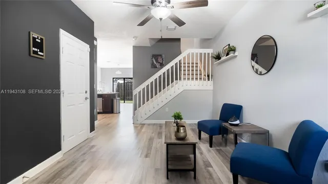 a view of entryway and hall with wooden floor