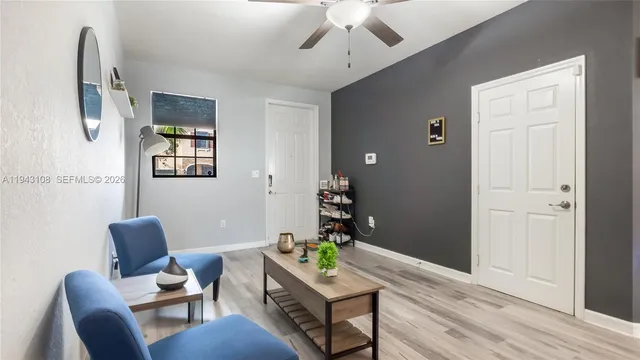 a living room with furniture and a wooden floor