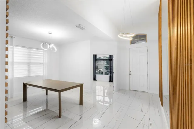 a kitchen with a refrigerator a stove top oven and cabinets
