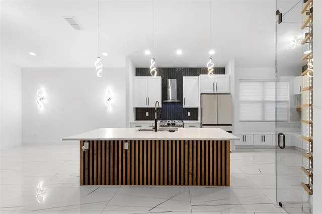 a kitchen with stainless steel appliances a sink stove and refrigerator