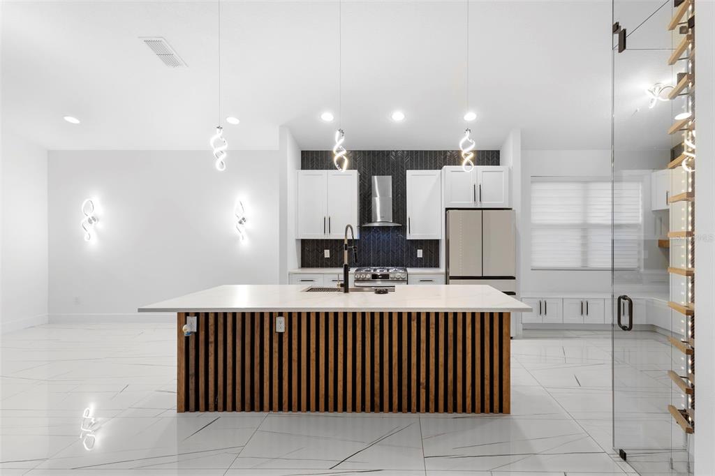 2342 Kaley Ridge Road Clermont, FL 34715 - Photo 18 of 54 a kitchen with kitchen island granite countertop a sink and cabinets